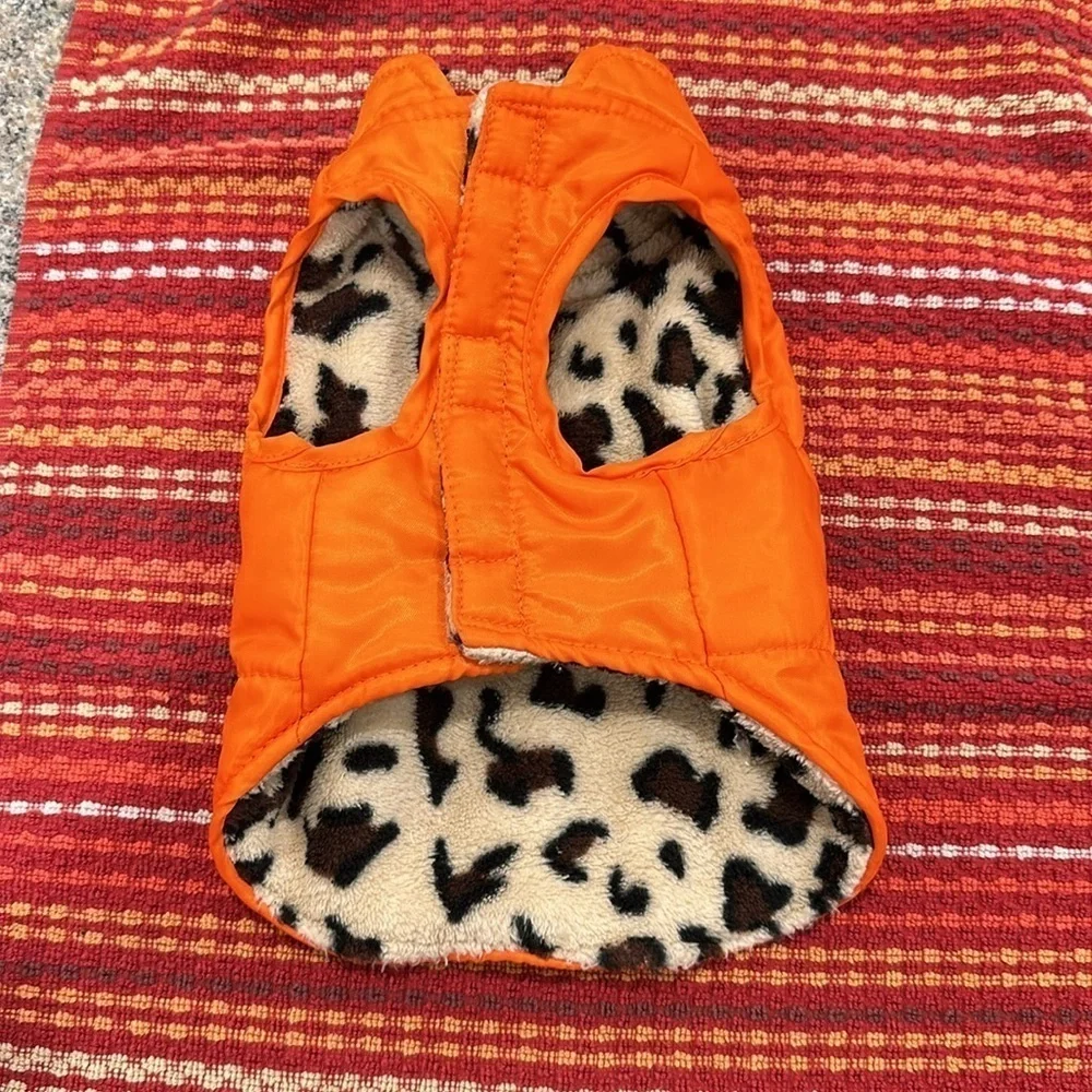 Small orange dog vest pockets are for decoration only.